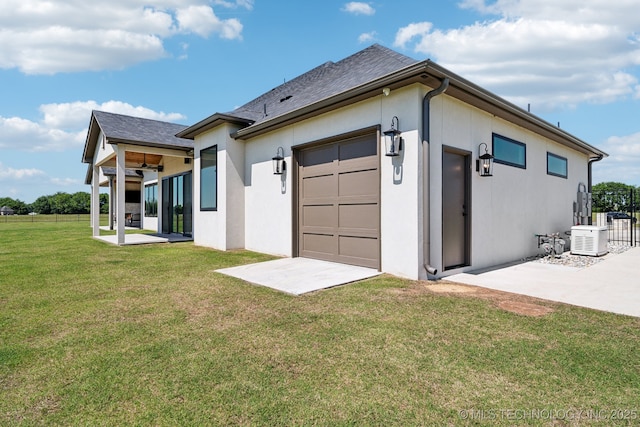8499 S Timber Wolf Dr, Broken Arrow, OK 74014 - back of house featuring a garage, stucco siding, roof with shingles, and a patio