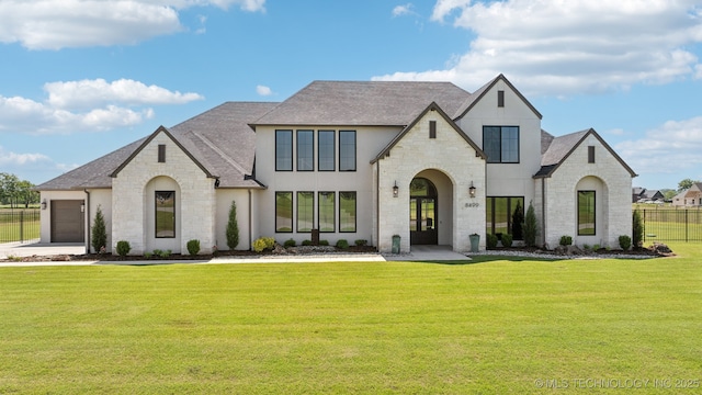 8499 S Timber Wolf Dr, Broken Arrow, OK 74014 - french provincial home featuring stone siding, a shingled roof, and a garage