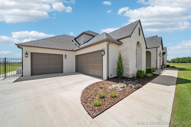 8499 S Timber Wolf Dr, Broken Arrow, OK 74014 - view of front of house featuring a garage, concrete driveway, fence, stucco siding, and stone siding