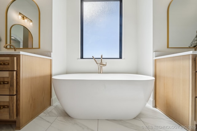 8499 S Timber Wolf Dr, Broken Arrow, OK 74014 - full bathroom with marble finish floors, a freestanding tub, and vanity