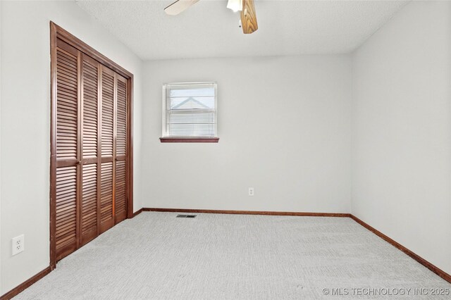 8508 E 123rd St S, Bixby, OK 74008 - unfurnished bedroom with a closet, baseboards, carpet flooring, a ceiling fan, and a textured ceiling