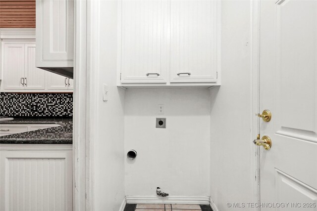 8508 E 123rd St S, Bixby, OK 74008 - laundry area featuring cabinet space, electric dryer hookup, baseboards, and tile patterned flooring