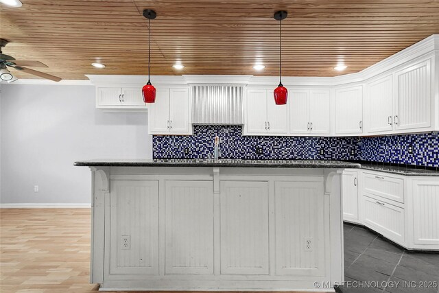 8508 E 123rd St S, Bixby, OK 74008 - kitchen featuring wooden ceiling, a ceiling fan, white cabinets, baseboards, and decorative backsplash
