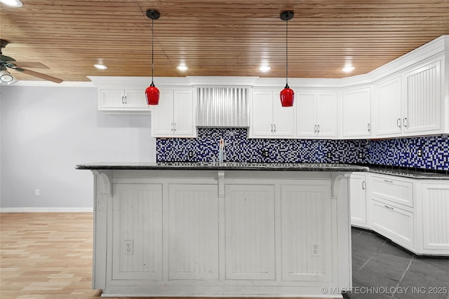 8508 E 123rd St S, Bixby, OK 74008 - kitchen featuring wooden ceiling, white cabinets, ceiling fan, backsplash, and a kitchen island