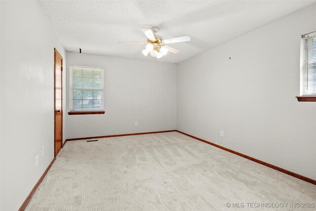 8508 E 123rd St S, Bixby, OK 74008 - unfurnished room with healthy amount of natural light, a ceiling fan, a textured ceiling, and baseboards