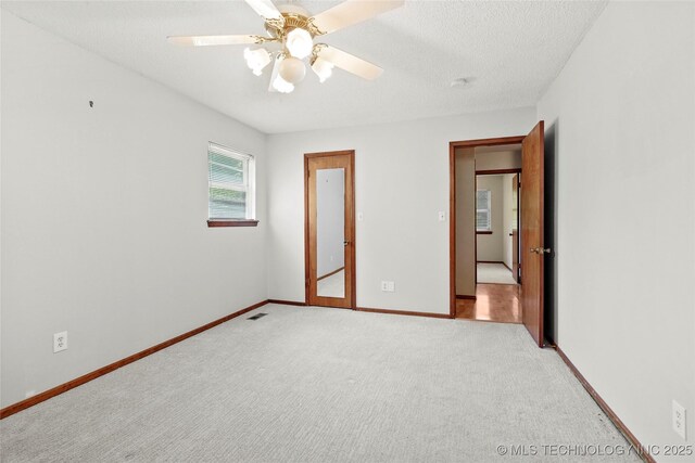 8508 E 123rd St S, Bixby, OK 74008 - unfurnished bedroom featuring light colored carpet, baseboards, a textured ceiling, and ceiling fan