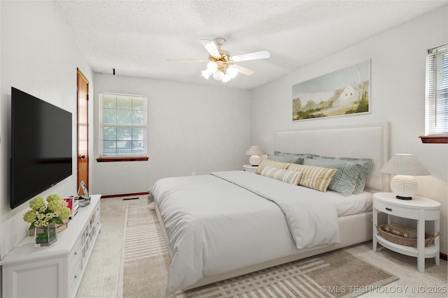 8508 E 123rd St S, Bixby, OK 74008 - bedroom featuring multiple windows, carpet flooring, a textured ceiling, and ceiling fan