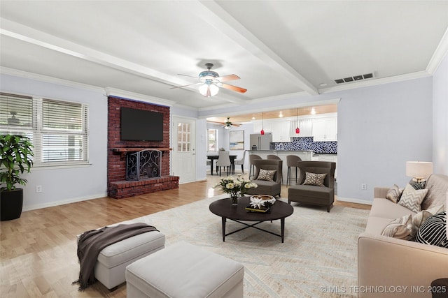 8508 E 123rd St S, Bixby, OK 74008 - living area featuring a ceiling fan, light wood finished floors, beam ceiling, a brick fireplace, and ornamental molding