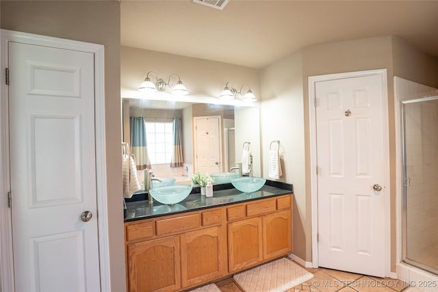 11636 S 102nd E Ave, Bixby, OK 74008 - bathroom featuring tile patterned floors, a shower stall, and double vanity