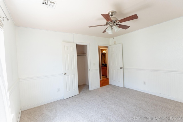 11636 S 102nd E Ave, Bixby, OK 74008 - unfurnished bedroom featuring carpet floors, wainscoting, ceiling fan, and a closet
