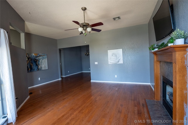 11636 S 102nd E Ave, Bixby, OK 74008 - unfurnished living room featuring wood finished floors, a ceiling fan, a tile fireplace, and baseboards