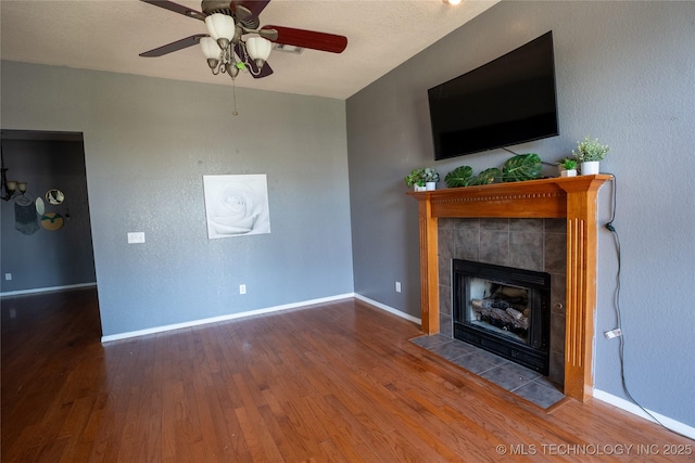 11636 S 102nd E Ave, Bixby, OK 74008 - unfurnished living room featuring wood finished floors, a fireplace, ceiling fan, and baseboards