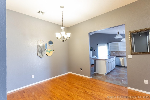 11636 S 102nd E Ave, Bixby, OK 74008 - kitchen featuring stainless steel dishwasher, wood finished floors, a chandelier, and hanging light fixtures