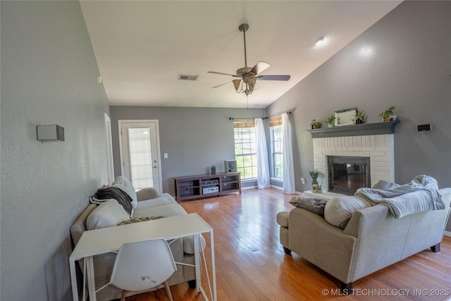 11636 S 102nd E Ave, Bixby, OK 74008 - living area with light wood-style floors, vaulted ceiling, ceiling fan, a fireplace, and baseboards