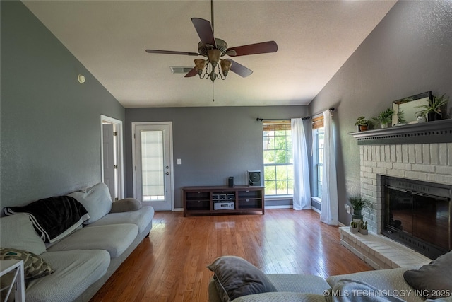 11636 S 102nd E Ave, Bixby, OK 74008 - living area featuring lofted ceiling, ceiling fan, wood finished floors, a fireplace, and baseboards