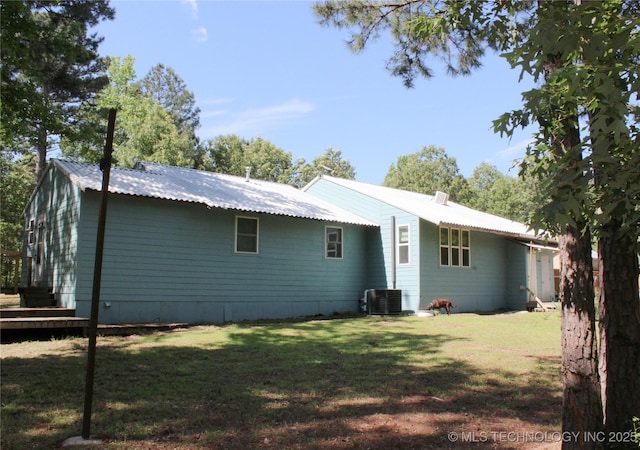 423118 E 1944th Ln, Antlers, OK 74523 - rear view of house with central air condition unit, a yard, metal roof, and a wooden deck