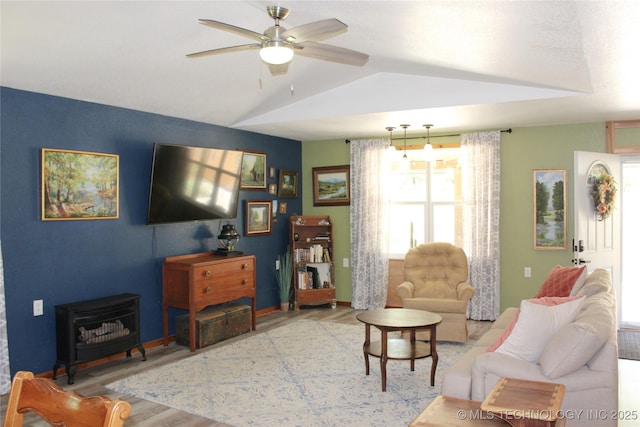 423118 E 1944th Ln, Antlers, OK 74523 - living room featuring a wood stove, wood finished floors, ceiling fan, and lofted ceiling