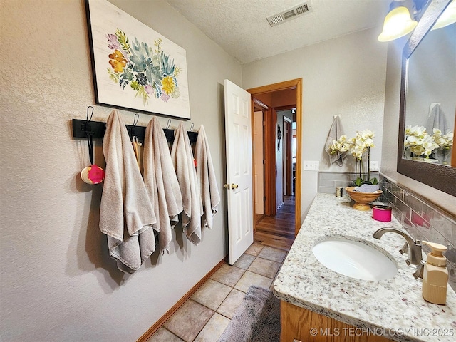 35824 S Talon Dr, Cookson, OK 74427 - bathroom with a textured ceiling, vanity, tile patterned floors, and a textured wall