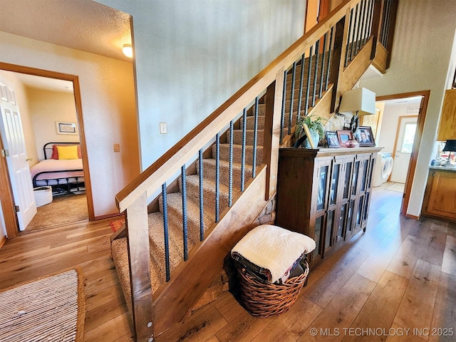 35824 S Talon Dr, Cookson, OK 74427 - stairs featuring wood-type flooring, washer and clothes dryer, and baseboards