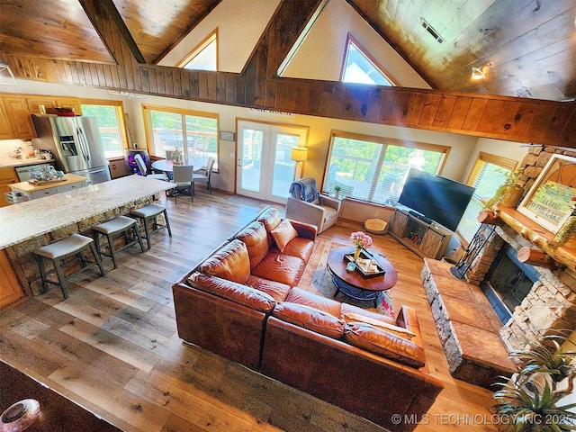 35824 S Talon Dr, Cookson, OK 74427 - living area with wooden ceiling, light wood-type flooring, a fireplace with raised hearth, plenty of natural light, and high vaulted ceiling