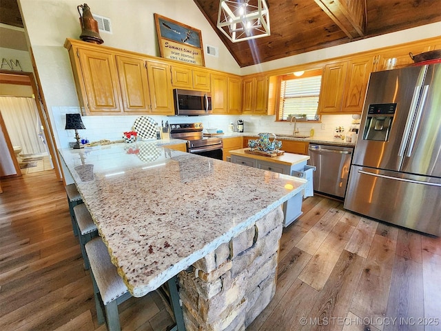 35824 S Talon Dr, Cookson, OK 74427 - kitchen with stainless steel appliances, light wood-style flooring, a sink, a peninsula, and light stone countertops