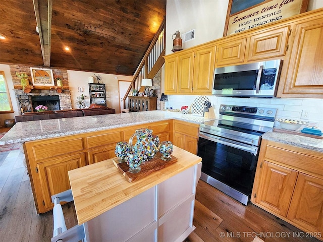 35824 S Talon Dr, Cookson, OK 74427 - kitchen with appliances with stainless steel finishes, wooden ceiling, a peninsula, hardwood / wood-style flooring, and a stone fireplace