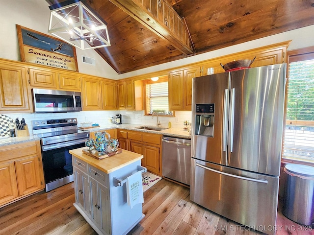 35824 S Talon Dr, Cookson, OK 74427 - kitchen with appliances with stainless steel finishes, a sink, light wood finished floors, a chandelier, and decorative backsplash