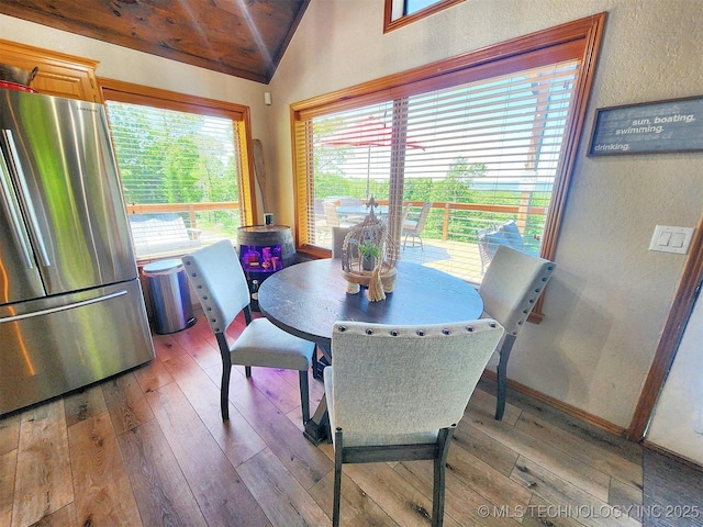 35824 S Talon Dr, Cookson, OK 74427 - dining area featuring vaulted ceiling, light wood finished floors, a textured wall, wood ceiling, and baseboards