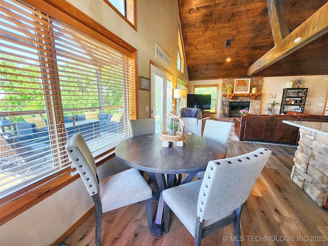 35824 S Talon Dr, Cookson, OK 74427 - dining room with hardwood / wood-style floors, a stone fireplace, high vaulted ceiling, healthy amount of natural light, and wood ceiling