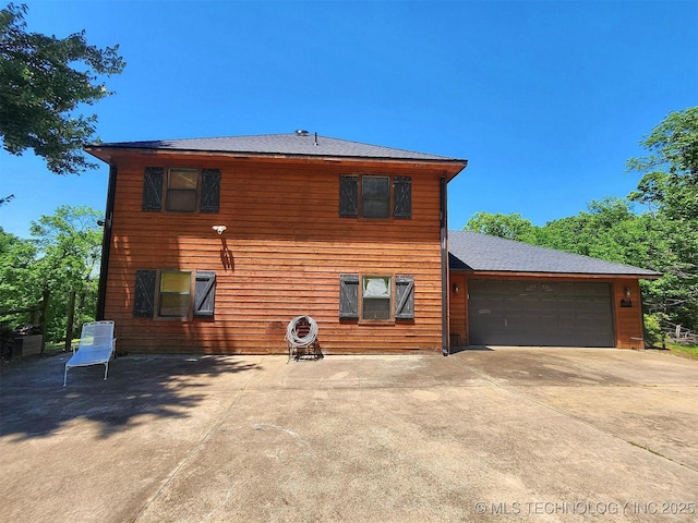 35824 S Talon Dr, Cookson, OK 74427 - rear view of property featuring concrete driveway and a garage