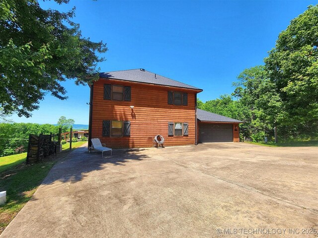 35824 S Talon Dr, Cookson, OK 74427 - back of property featuring a shingled roof and a garage