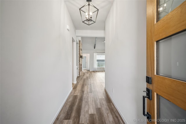 2044 E 138th Pl S, Bixby, OK 74008 - hallway featuring a chandelier, dark wood-type flooring, and baseboards