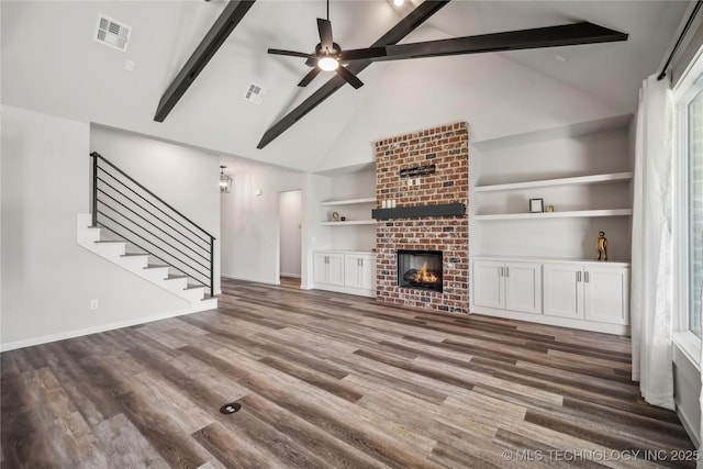 2044 E 138th Pl S, Bixby, OK 74008 - unfurnished living room featuring high vaulted ceiling, beam ceiling, stairway, baseboards, and wood finished floors