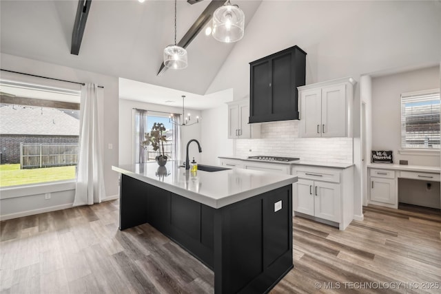 2044 E 138th Pl S, Bixby, OK 74008 - kitchen with a sink, gas stovetop, light countertops, a chandelier, and an island with sink