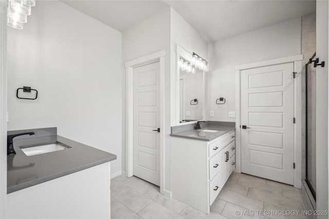 2044 E 138th Pl S, Bixby, OK 74008 - bathroom featuring vanity, tile patterned flooring, and a shower with door