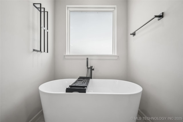 2044 E 138th Pl S, Bixby, OK 74008 - bathroom featuring a soaking tub and baseboards