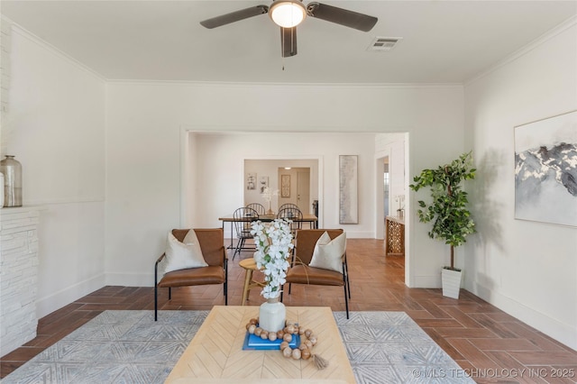 living room with ornamental molding, a ceiling fan, and baseboards