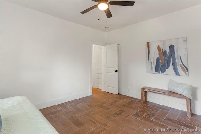 unfurnished bedroom featuring baseboards and a ceiling fan