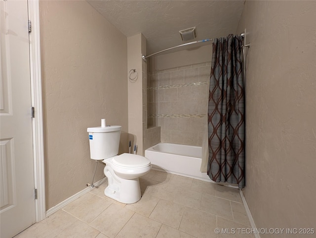 bathroom with a textured wall, tile patterned flooring, a textured ceiling, toilet, and shower / tub combo with curtain
