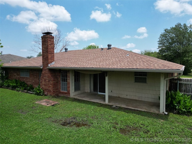 1703 Vaden Ln, Ardmore, OK 73401 - back of house featuring roof with shingles, a patio area, a chimney, and a yard