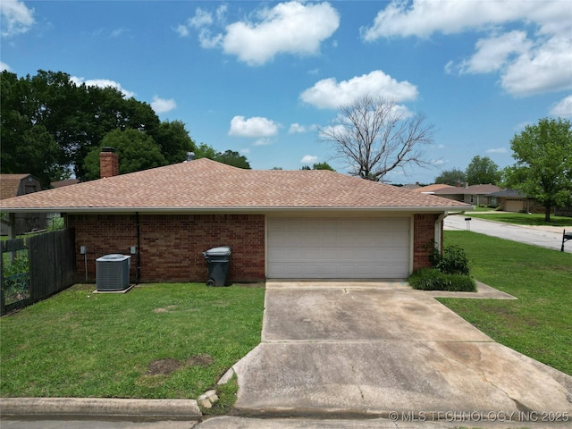 1703 Vaden Ln, Ardmore, OK 73401 - view of side of property with central AC unit, brick siding, concrete driveway, a chimney, and roof with shingles