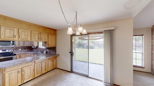 1703 Vaden Ln, Ardmore, OK 73401 - kitchen with appliances with stainless steel finishes, light brown cabinets, and light colored carpet