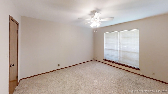 1703 Vaden Ln, Ardmore, OK 73401 - empty room with light carpet, a ceiling fan, and baseboards