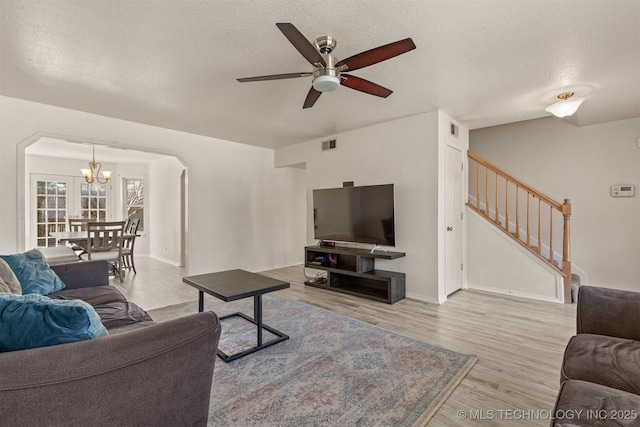 619 S Magnolia Pl, Broken Arrow, OK 74012 - living area featuring a chandelier, stairs, a ceiling fan, wood finished floors, and a textured ceiling