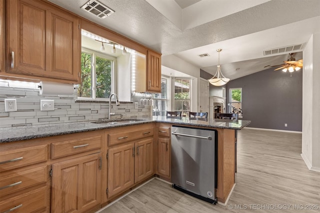 619 S Magnolia Pl, Broken Arrow, OK 74012 - kitchen featuring dishwasher, a sink, light wood finished floors, decorative backsplash, and lofted ceiling