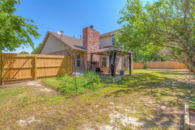 619 S Magnolia Pl, Broken Arrow, OK 74012 - rear view of property featuring a gazebo, a chimney, brick siding, and a patio area