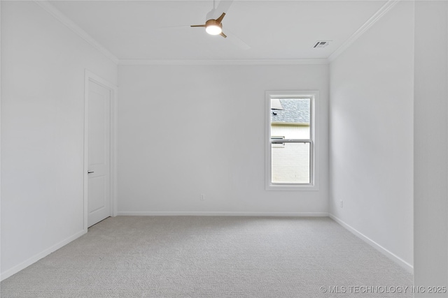 spare room with ornamental molding, light carpet, baseboards, and ceiling fan