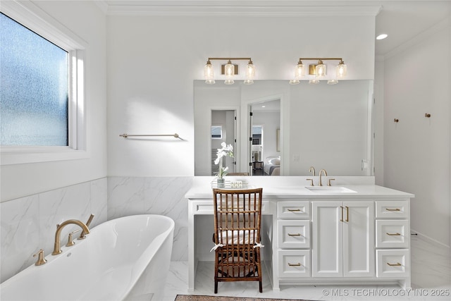 full bath featuring marble finish floors, connected bathroom, ornamental molding, a freestanding bath, and vanity
