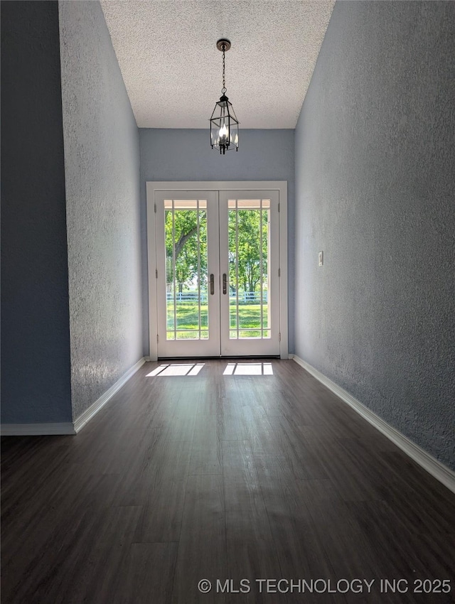 9533 E 136th St, Bixby, OK 74008 - spare room featuring a textured wall, wood finished floors, a chandelier, french doors, and baseboards