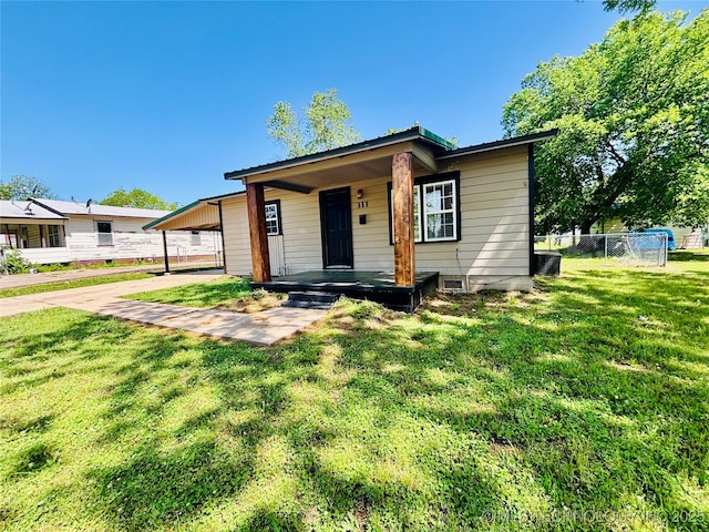 view of front of house with an attached carport, covered porch, driveway, and central air condition unit
